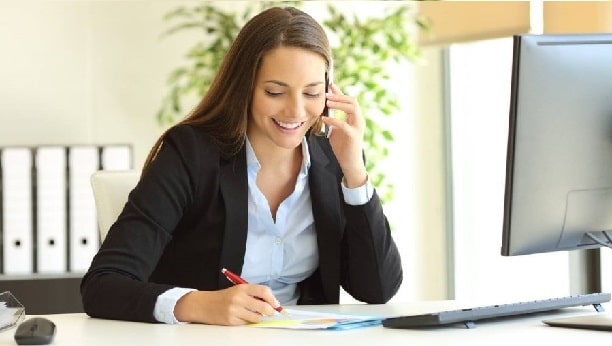 Woman talking on the phone behind a desk