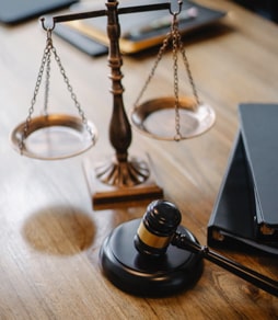 A gavel and scales on a desk