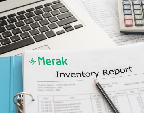 A close-up of a ring binder containing a Merak Inventory Report