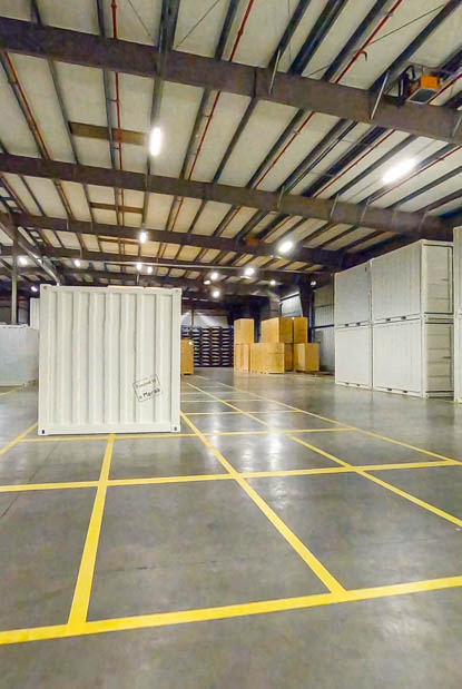A spacious storage space with clearly marked yellow lines on the floor, providing organization and guidance.