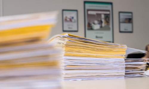 An employee of Merak sitting at her desk and busy scanning