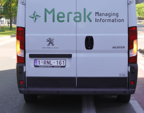 The back of a van with merak on the door in green letters